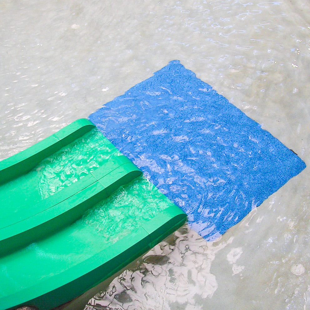 AquaSeal safety surfacing landing pad installed at a water slide exit